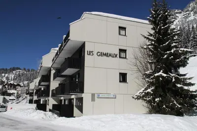 a building with the words us germany on it in the snow at Résidence Gemeaux - Studio confortable · Centre station · Balcon MAE-7844 in Magland