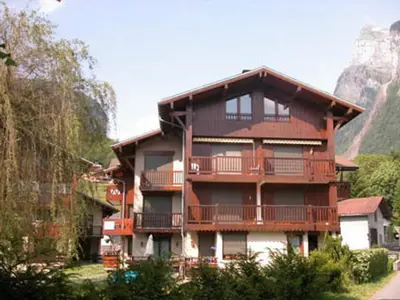 a large apartment building with balconies on a mountain at Appartement rénové avec terrasse et parking, fibre incluse - FR-1-629-127 in Samoëns