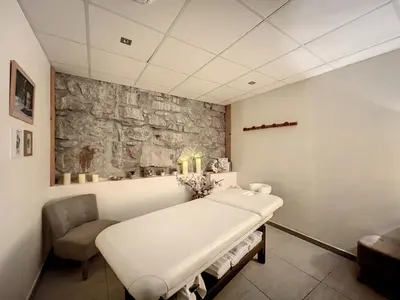 a hospital room with a bed and a stone wall at Chalet de Luxe 6 Chambres avec Piscine et Bien-Être à Combloux - FR-1-560-107 in Combloux