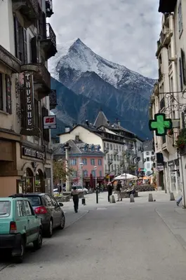 a mountain in the background of a city with cars at Apartment Bonatti 201 in Chamonix-Mont-Blanc