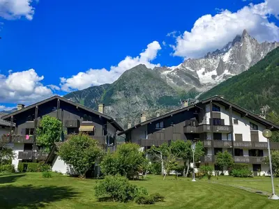 a building in the middle of a field with trees at Apartment Champraz-17 by Interhome in Chamonix-Mont-Blanc
