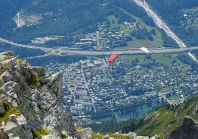 two kites flying over a city on a mountain at Gentianes - City center studio next to Aiguille du Midi lift - By Cozee Rentals in Chamonix-Mont-Blanc