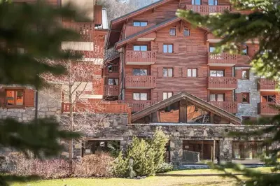 a large wooden building with balconies on it at Résidence Les Fermes du Soleil - maeva Home - Appartement 3 Pièces 6 Personnes - Sélection MAE-6505 in Les Carroz d'Araches