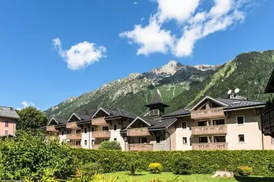 a bridge over a city with a mountain in the background at Résidence La Ginabelle - maeva Home - Appartement vue mont blanc 3 pièces 6 personnes avec parking - Prestige MAE-8604 in Chamonix-Mont-Blanc
