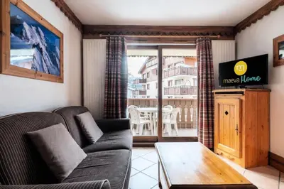 a living room with a couch and a table at Résidence La Ginabelle - maeva Home - Appartement 3 pièces 6 personnes - Prestige MAE-3904 in Chamonix-Mont-Blanc