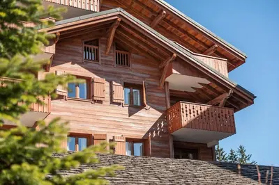 a wooden house with a balcony on top of a roof at Résidence Les Fermes du Soleil - maeva Home - Appartement 3 pièces 6 personnes - Sélection MAE-8007 in Les Carroz d'Araches