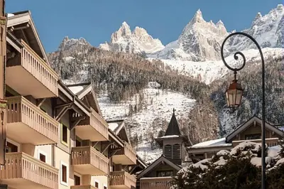 a view of a snow covered mountain with buildings and a street light at Résidence La Ginabelle - maeva Home - 4 Pièces 6 Personnes - Prestige MAE-1506 in Chamonix-Mont-Blanc