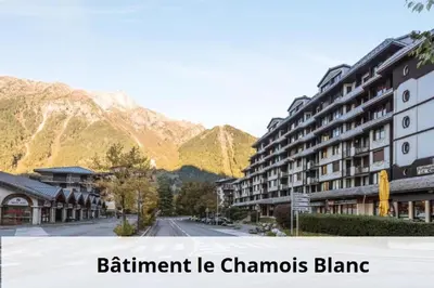 a street in a town with mountains in the background at L'Aiguille - maeva Home - 2 Pièces 5 Personnes Confort MAE-2139 in Chamonix-Mont-Blanc