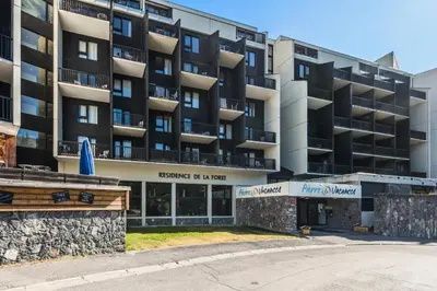 an apartment building in front of a street at Résidence La Forêt - maeva Home - Appartement 2 Pièces 5 Personnes - Confort MAE-4236 in Flaine