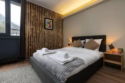 a bedroom with a large bed with towels on it at Beautiful cosy, modern studio in Chamonix centre in Chamonix-Mont-Blanc