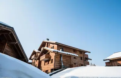 an old wooden building with snow on it at Résidence Les Fermes du Soleil - maeva Home - Appartement 3 pièces 6 personnes - Prestige MAE-0374 in Les Carroz d'Araches