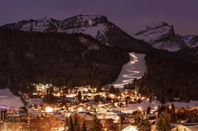a town in the snow at night with mountains at GRD005 - Appartement standing 6 pers pied de piste in Les Carroz d'Araches