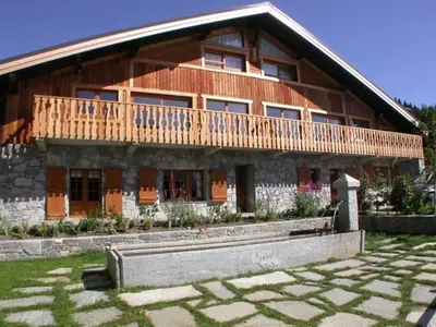 a large wooden house with a wooden deck on it at Appartement 3 pièces - 6 pers - Proche pistes et commerces, navette gratuite - FR-1-572-19 in Arâches-la-Frasse