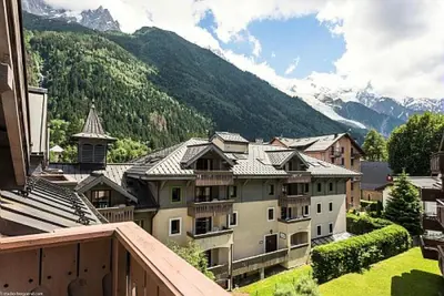 a view from a balcony of a town with mountains at Résidence La Ginabelle - maeva Home - Appartement 4 Pièces 8 Personnes - Sélection MAE-7444 in Chamonix-Mont-Blanc
