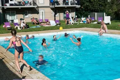 a group of people playing in a swimming pool at Be first on the lift each morning! 2bed apt. 6 pax in Saint-Gervais-les-Bains