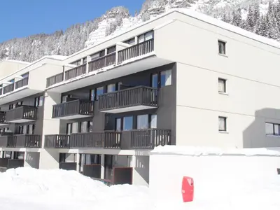 a building with snow in front of a mountain at Studio rénové à Flaine · Balcon Sud · Idéal pour 4 personnes - FR-1-425-209 in Arâches-la-Frasse