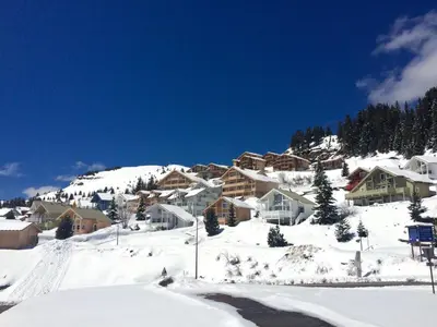 a snow covered mountain with houses on a hill at Chalet lumineux à Flaine avec garage et grand salon - FR-1-425-210 in Arâches-la-Frasse