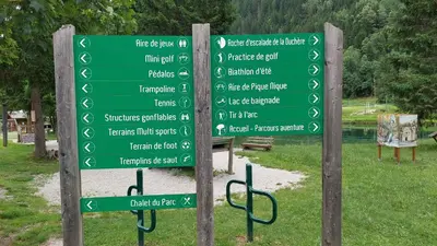 a bunch of green signs in a park at Studio au pied des remontées/wifi/smart TV/parking in Les Contamines-Montjoie