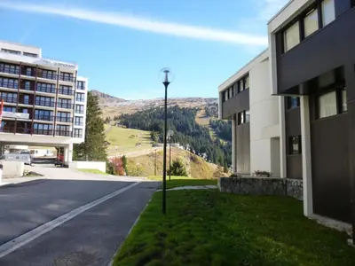an empty street next to a building with a street light at Appartement rénové 6 pers, balcon, au pied des pistes - FR-1-425-221 in Arâches-la-Frasse