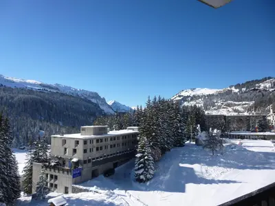 a building in the snow with trees and mountains at Appartement spacieux, balcon, skis aux pieds - 8 pers. - FR-1-425-216 in Arâches-la-Frasse
