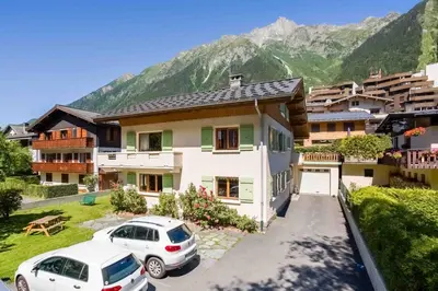 a living room with a wooden table and a couch at Edelweiss 2 Apartment in Chamonix-Mont-Blanc