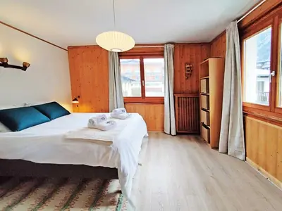 a bedroom with a bed with towels on it at Edelweiss 2 Apartment in Chamonix-Mont-Blanc
