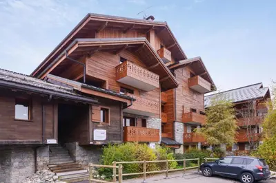a building with a car parked in front of it at Résidence Les Fermes du Soleil - maeva Home - Appartement 3 Pièces 6 Personnes - Sélection MAE-1543 in Arâches-la-Frasse