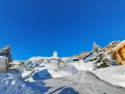 a village covered in snow with a church at Les Chalets de Flaine Hameau - maeva Home - Chalet 7 Pièces 12 Personnes - Prestige MAE-3379 in Flaine