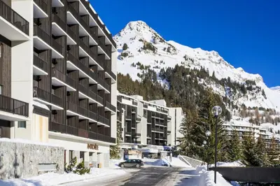 a snow covered mountain in front of a building at Résidence Andromède - maeva Home - Studio 4 Personnes - Confort MAE-3650 in Flaine