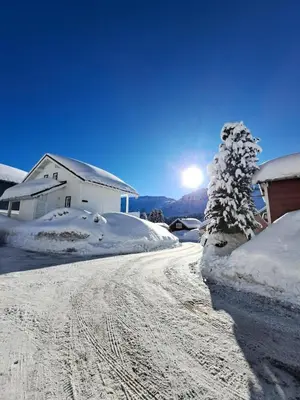a snow covered road with a house and a tree at Les Chalets de Flaine Hameau - maeva Home - Chalet 7 Pièces 12 Personnes - Sélection MAE-3656 in Flaine