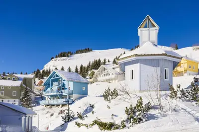 a small town with a church in the snow at Les Chalets de Flaine Hameau - maeva Home - Chalet 4 Pièces 8 Personnes - Confort MAE-3660 in Flaine