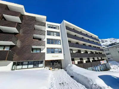 a hotel in the snow in front of a building at Résidence Pégase - maeva Home - Appartement 3 Pièces 8 personnes - Sélection MAE-3663 in Flaine