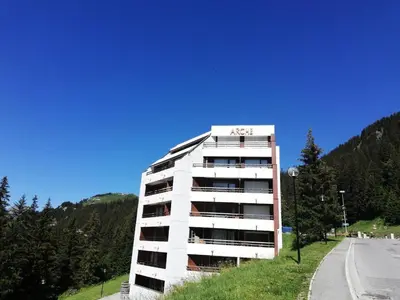 a white apartment building on the side of a road at Résidence Arche - maeva Home - Appartement 2 Pièces 6 Personnes - Confort MAE-3694 in Arâches-la-Frasse