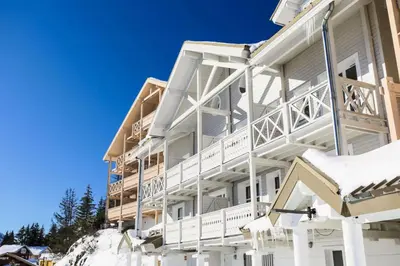 a white apartment building with snow on the ground at Résidence Le Château de Crans - maeva Home - Appartement 3 Pièces 8 Personnes - Confort MAE-4488 in Flaine