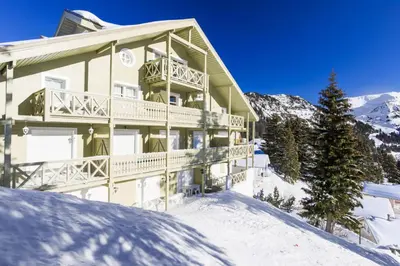 a large building in the snow with snow at Résidence Arbaron - maeva Home - Appartement 3 Pièces 8 Personnes - Budget MAE-4591 in Flaine