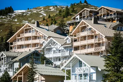 a group of houses on the side of a mountain at Résidence Le Château de Crans - maeva Home - Appartement 2 Pièces 6 Personnes - Sélection MAE-4725 in Flaine