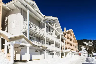 a large white building with snow on the ground at Résidence Le Château de Crans - maeva Home - Appartement 2 Pièces 6 Personnes - Sélection MAE-4725 in Flaine