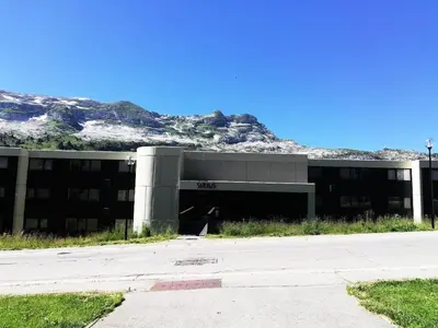 an office building with a mountain in the background at Résidence Sirius - maeva Home - Studio 4 personnes - Confort MAE-3534 in Arâches-la-Frasse