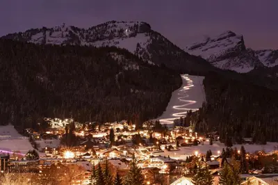 a town in the snow at night with mountains at GR450 6 Pers Centre Carroz in Les Carroz d'Araches