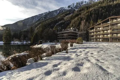 a snow covered path in front of a lodge at Lac des Gaillands - Renove - Balcon avec vues in Chamonix-Mont-Blanc
