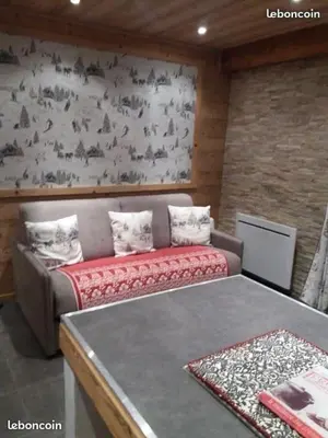 a room with a couch and a wall with sheep at standing 4 étoiles in Demi-Quartier