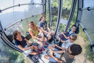 a group of people sitting in a gondola ride at LUTB17 - Duplex 6 personnes au pied des pistes in Les Carroz d'Araches