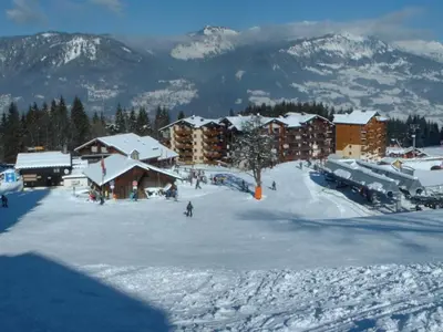 a ski resort in the snow with mountains in the background at Bel appartement 3 ch, au pied des pistes avec wifi - FR-1-642-93 in Morillon