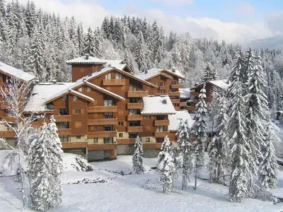 a log cabin building in the snow with trees at Bel appartement 3 ch, au pied des pistes avec wifi - FR-1-642-93 in Morillon