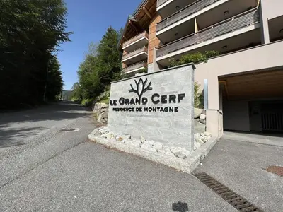 a sign in front of a building with a building at GCB103 Appartement 10 personnes in Les Carroz d'Araches