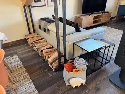 a living room with a couch and a tv at Chalet Aspre in Samoëns
