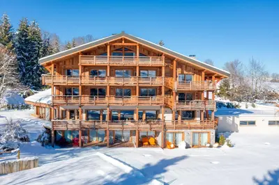 an image of a log cabin in the snow at Appartement Horizon Panoramique - Welkeys in Combloux
