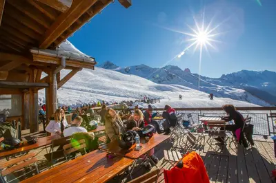 a group of people sitting on a deck on a ski slope at Résidence Le Cristal - Grands Montets 9 - Happy Rentals in Chamonix-Mont-Blanc