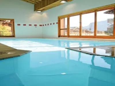 an empty swimming pool with blue floors and windows at Chalet avec terrasse et animaux acceptés, proche centre et ski-bus - FR-1-624-169 in Samoëns