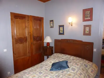 a bedroom with a bed with a blue pillow on it at Chalet station jusqu'à 13 personnes 5 nuits minimum ou 7 en période de vacances scolaires in Samoëns